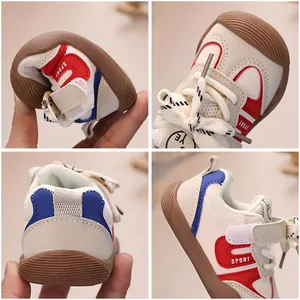 White soft-sole baby walking shoes with red and blue sport design and flexible rubber sole