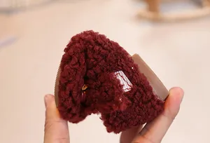 Detail showing the ultra-flexible non-slip sole of the plush winter baby shoe in burgundy