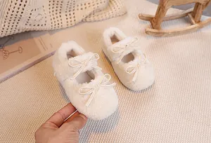 Detail of plush cream Mary Jane shoes for girls with decorative leather bow straps