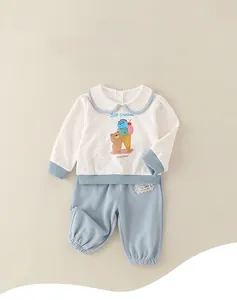Close-up of baby girl cotton two-piece set featuring blue polka dots and a cute bear design