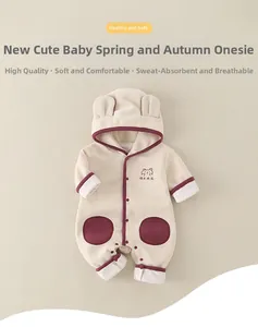 Détail d'une grenouillère à capuche avec oreilles d'ours et bordure bordeaux en coton