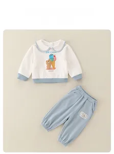 Detail of baby girl cotton outfit set with bear print and lace pocket pants