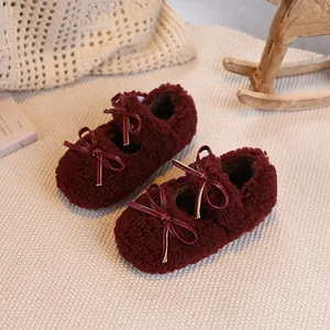 Sherpa lined burgundy baby girl Mary Jane shoes with ribbon bow in a cozy home setting