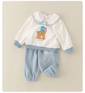 Detailed flat lay of a cotton baby set featuring polka dots and ice cream prints