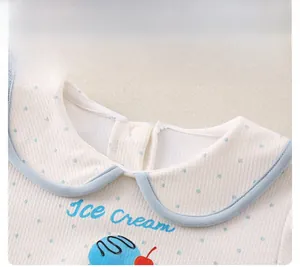 Detail of waffle fabric baby top with Peter Pan collar and ice cream print