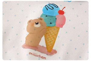 Close-up of soft waffle cotton fabric featuring a cute cartoon bear and ice cream print