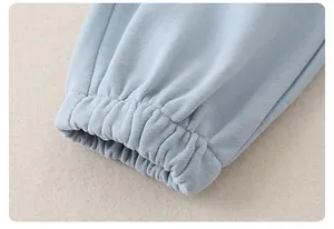Detail of elastic ribbed cuffs on a light blue cotton sweatshirt for infant girls