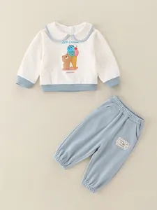 Cute two-piece baby girl set with polka dot sweatshirt and lace-trimmed blue pants