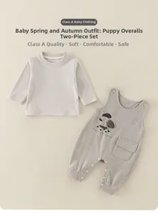 Detail of infant two-piece set featuring cute puppy overalls and long sleeve soft shirt