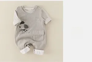 Detail of infant gray romper showing cartoon dog print and functional shoulder buttons