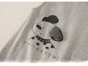 Close-up of baby vest featuring knitted texture and cute cartoon dog with wonderful text