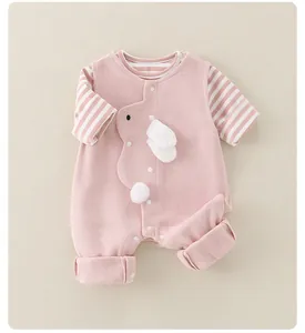 Detail view of pink cotton baby bodysuit with 3D bunny ears and striped sleeves