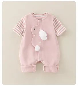 Detail of pink cotton baby bodysuit with bunny embroidery and soft 3D plush tail detail