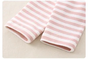 Detail of soft pink and white striped cotton knit cuffs with precise stitching finish