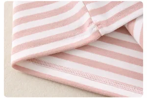 Detailed close-up of pink and white striped cotton knit fabric with reinforced stitching
