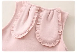 Close-up of pink knitted baby vest featuring cute ruffled rabbit ear details on the back