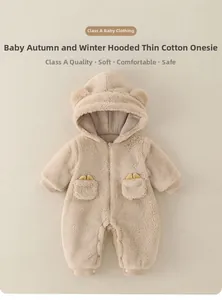 Detailed close-up of beige toddler hooded romper with soft fleece texture and cute bear ears