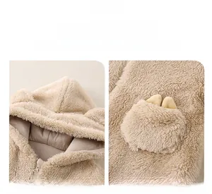 Detailed view of the cute 3D ears on the hood and pocket of this infant fleece romper