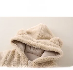 Close-up of cozy beige sherpa fleece baby romper with cute 3D bear ears and hood details
