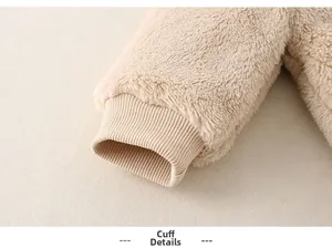 Close-up of baby romper ribbed cuffs and soft beige fleece material details