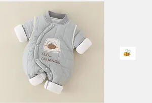 Close-up of baby romper showing blue quilted fabric and cute cartoon bear embroidery