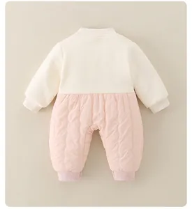 Detail view of baby romper featuring a ribbed knit top and quilted pink bottom