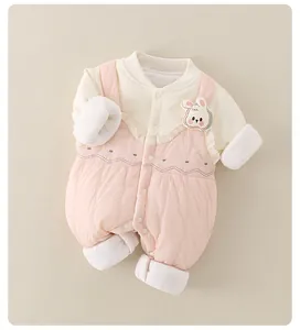 Close-up of pink quilted baby romper with rabbit patch and floral embroidery details