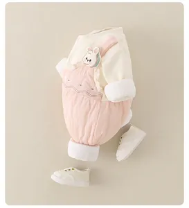 Detailed view of baby romper featuring 3D bunny doll and delicate flower embroidery