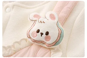 Detail of baby quilted cotton romper with cute rabbit embroidery and lace trim