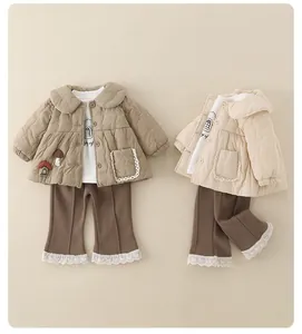 Flat lay of baby winter set with quilted mushroom jacket and lace hem flare pants