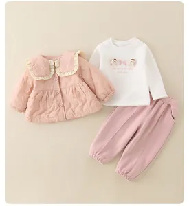 Detail of pink quilted cardigan and white top with bear embroidery for girls