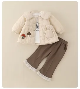 Detail view of quilted beige jacket with mushroom patch and brown lace hem pants