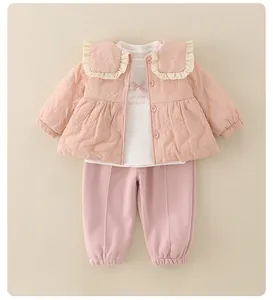 Three-piece baby girl set featuring pink quilted jacket with ruffled collar and pants