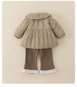 Close-up of quilted beige jacket with Peter Pan collar and lace-trimmed brown pants