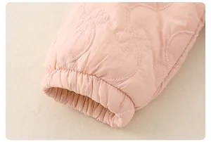 Close-up of pink quilted jacket cuff with bow stitching and elastic windproof wristband