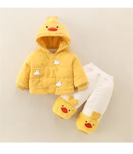 Detail of baby winter set with duck-themed yellow hooded jacket and white padded pants