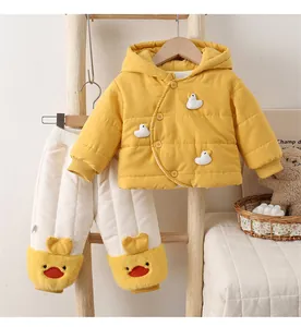 Detail of yellow quilted winter baby suit featuring cute 3D duck face embroidery on pants