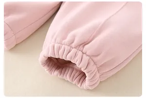 Detailed close-up of light pink ribbed elastic cuffs on warm cotton baby jacket