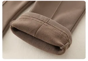Close-up of baby winter pants featuring thick brown knit fabric and warm fleece lining