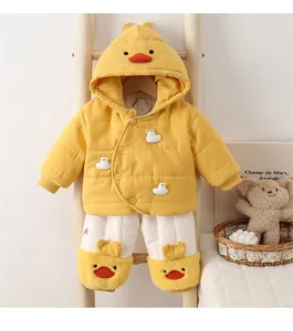 Detail of baby winter outfit with yellow duck hoodie and plush trousers on wooden hanger
