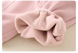 Close-up of pink thickened fleece lining and fine knit texture for toddler winter clothes