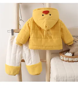 Detail of baby winter outfit with yellow animal hood and quilted trousers on wood rack