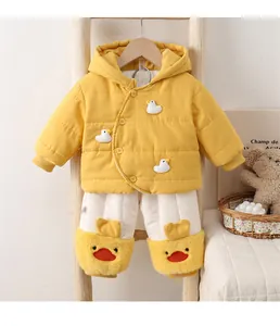 Detail of baby winter outfit with yellow puffer jacket and cartoon duck plush trousers