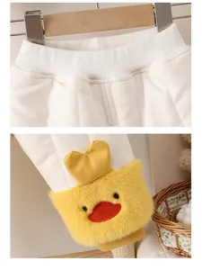 Detail of baby winter padded pants showing elastic waistband and cute yellow duck embroidery