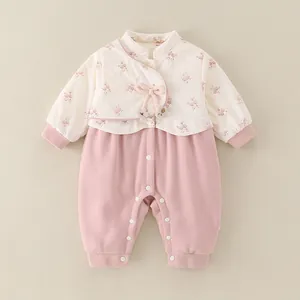 Floral quilted baby romper with pink bow detailing and convenient snap closure