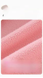 Gros plan sur le tissu polaire sherpa rose doux montrant une texture pelucheuse