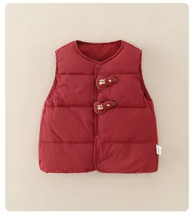 Detail of red quilted baby vest with golden Fu character gourd embroidery patches