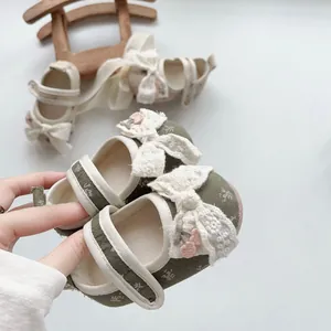 Detailed view of floral baby Mary Jane shoes with lace bow and velcro strap closure