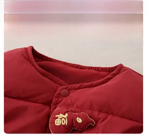 Detail of red baby down vest with gold Fu character embroidery and button closure