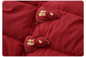 Detail of red quilted down vest featuring traditional Chinese gourd buttons and embroidery